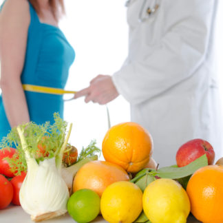 Doctor nutritionist measuring the waist of a patient